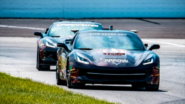 Paralyzed race car driver trying out a new system of hand controls for driving